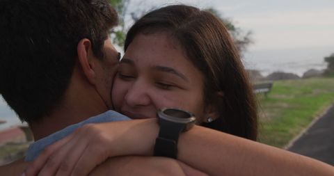 Happy Couple Embracing Outdoors in Summer Park