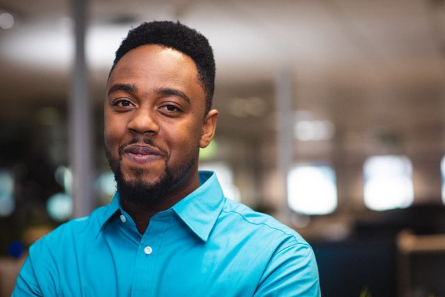 Portrait of smiling young african american businessman in office, copy space. unaltered, business, corporate business, occupation and office concept.