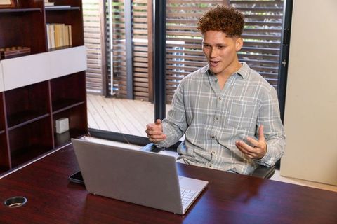 Man engaging in video call at home office