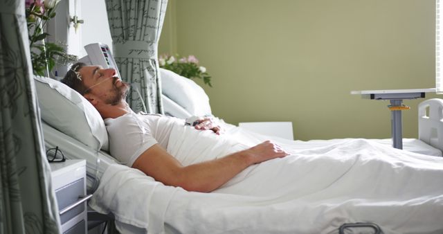 Man Resting in Hospital Bed with Medical Equipment - Download Free Stock Images Pikwizard.com