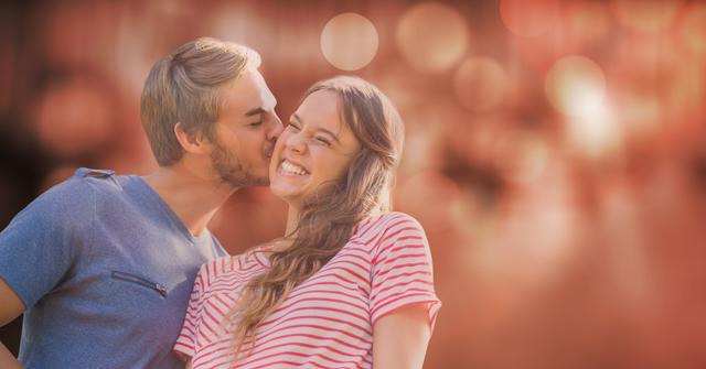 Digital composite of Man kissing woman over blur background