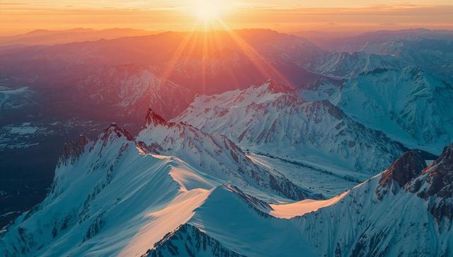 Spectacular Sunrise Over Snow-Capped Mountain Peaks
