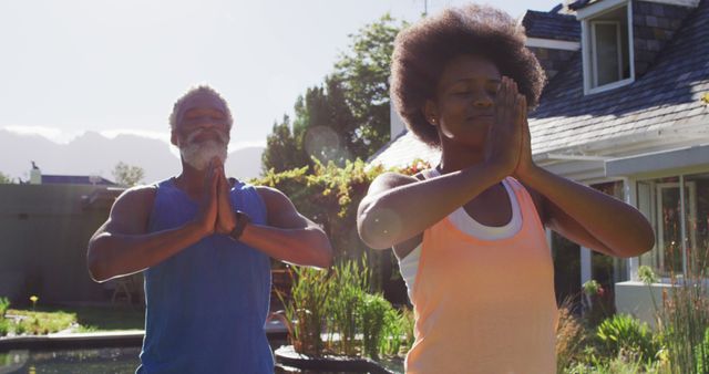 Senior Man and Young Woman Practicing Yoga Outdoors in Sunlit Garden - Download Free Stock Images Pikwizard.com