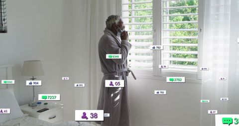 Elderly Man Engages with Social Media in Domestic Setting