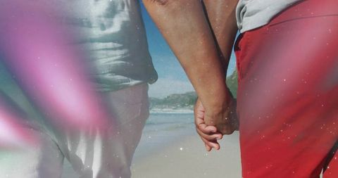 Couple Holding Hands Walking Beach on Sunny Day