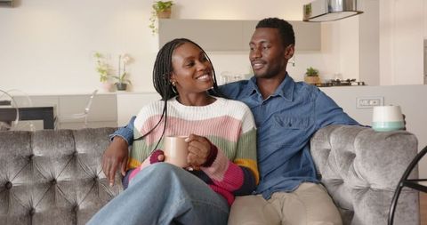 Couple Enjoying Cozy Moment on Sofa at Modern Home