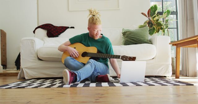 Young Man Learning Guitar at Home with Laptop in Cozy Living Room - Download Free Stock Images Pikwizard.com