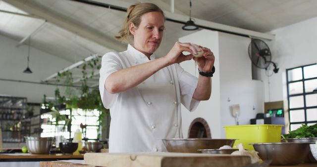 Professional chef preparing dough in modern kitchen. Chef uses various ingredients and tools to make food. Useful for culinary guides, recipe blogs, restaurant promotions, food magazines, and cooking tutorials.