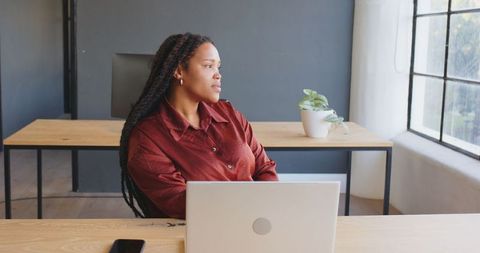 Businesswoman Contemplating Ideas in Modern Office