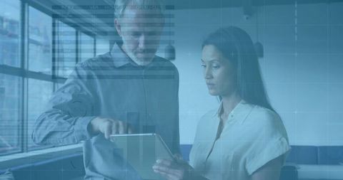 Professionals Collaborating in Modern Office on Tablet