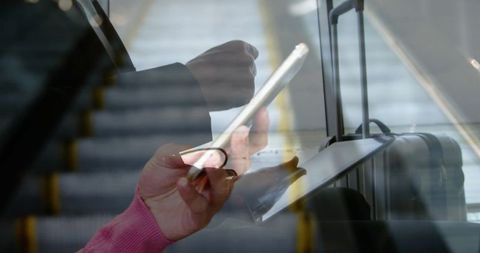 Business Professional Multitasking on Commute Using Tablet and Smartphone