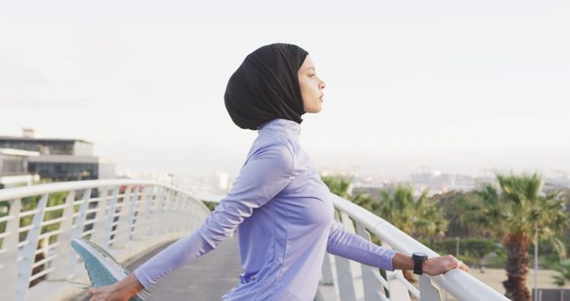 Muslim Woman Stretching on Bridge During Morning Workout - Download Free Stock Images Pikwizard.com