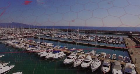 Docked pleasure boats in marina with hexagonal overlay