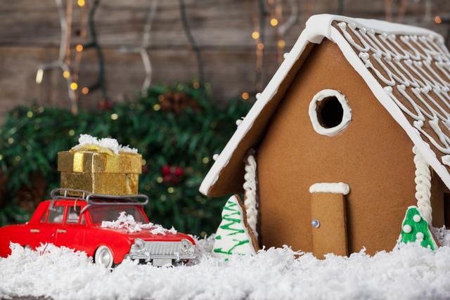 Gingerbread house and toy car arranged together during christmas time
