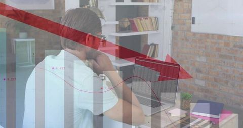 Analyst studying market downturn on laptop with red downward arrow and data charts