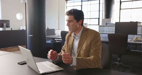 Businessman Engaging in Video Conference in Modern Office