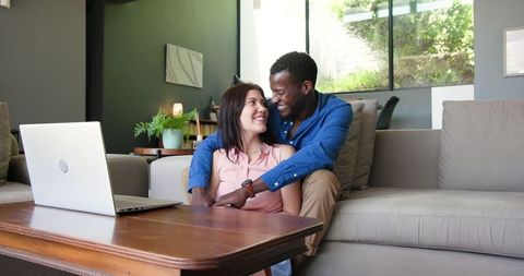 Happy multiracial couple announcing engagement via video call