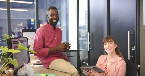 Smiling Diverse Coworkers Collaborate in Modern Office Setting