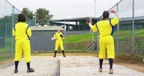 Female softball team in action practicing in bullpen