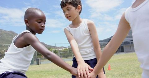 Diverse Children Embracing Teamwork and Unity Outdoors