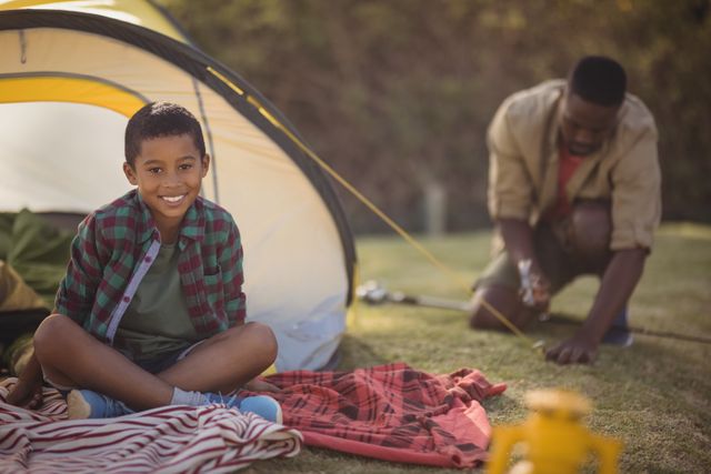 Portrait of smiling boy sitting in tent