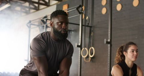 Diverse Fitness Enthusiasts Performing Strength Exercises at Gym