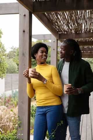 Happy Couple Enjoying Cozy Coffee Break on Outdoor Deck