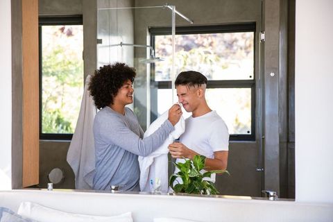 Couple sharing intimate moment in modern bathroom