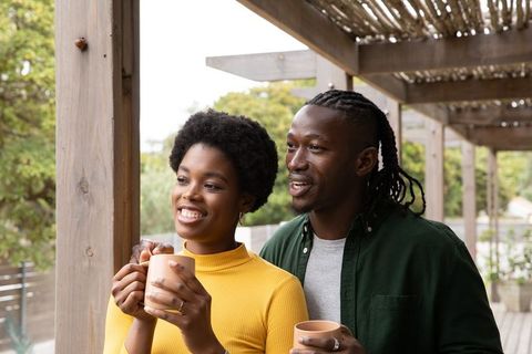Happy Couple Enjoying Coffee on Terrace Day