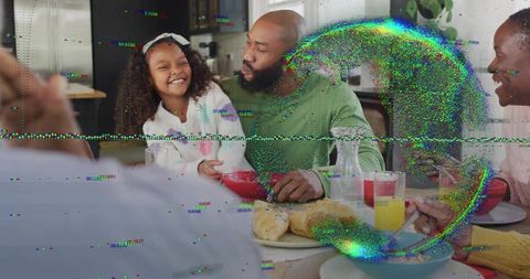 Black multigenerational family sharing joyful breakfast, father and daughter laughing