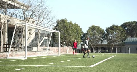 Soccer Practice on School Field with Goalkeeping Focus