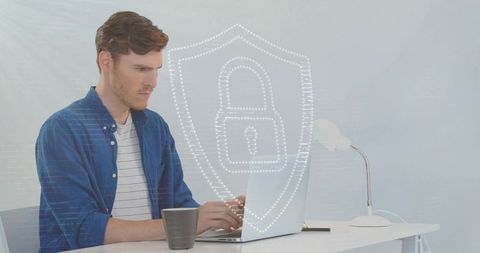 Man typing on laptop with digital security shield icon overlay
