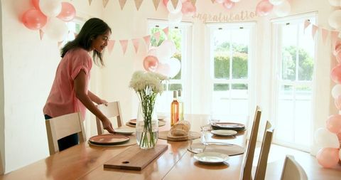 Woman Preparing Elegant Table for Celebration at Home