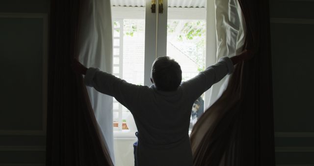 Rear view of senior biracial woman at home opening curtains - Download Free Stock Photos Pikwizard.com