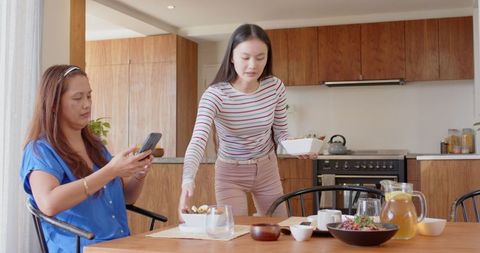 Mother and Daughter Sharing Time in Modern Kitchen