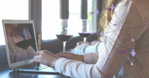 Professional Woman Typing on Laptop in Stylish Cafe Setting