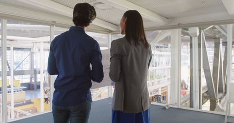 Professionals Discussing Project over Office Balcony with Copy Space