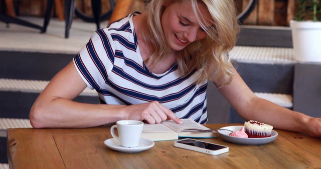 Woman Relaxing at Cafe with Book, Coffee, and Cupcake - Download Free Stock Images Pikwizard.com