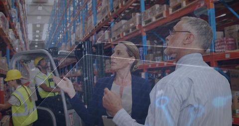 Two Managers Using Digital Technology in Industrial Warehouse
