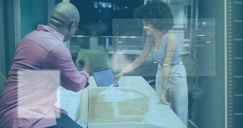 Architectural Discussion with Scale Model and Blueprints in Modern Office