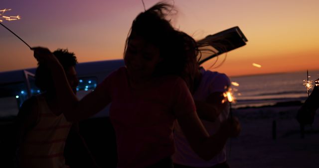 Friends Celebrating at Sunset with Sparklers on Beach - Download Free Stock Images Pikwizard.com