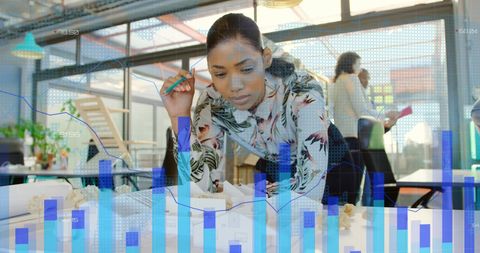 Engineer Analyzing Data Overlaid with Graph for Finance Insights