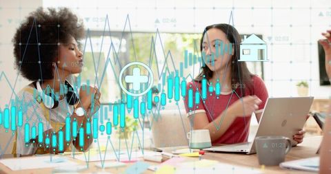 Collaborating on data analysis with laptop and financial charts overlay in modern workspace