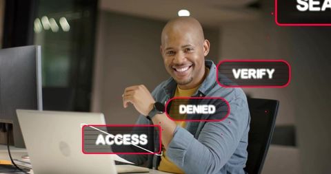 Smiling professional working on laptop with access denied and verify security overlays