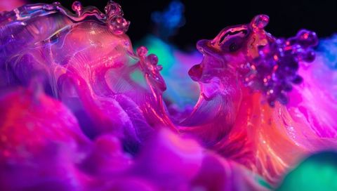 Glowing magenta resin waves forming glossy crests in neon macro abstract colorful ripple