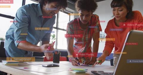 Diverse Team Collaborating on UX Mockups with Sticky Notes Laptop and Prototyping Workflow