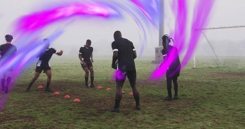 Foggy soccer training players passing drill with vivid purple motion streaks