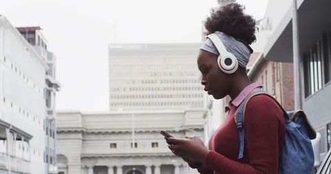 African American Woman Enjoying Music in Urban Environment