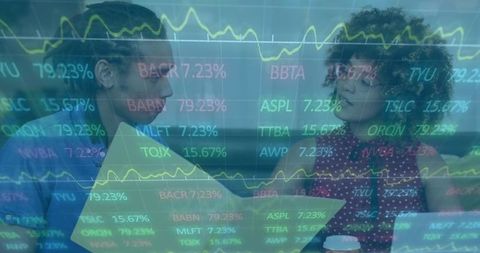 Discussing stock charts with data overlay, colleagues collaborating on investment analysis