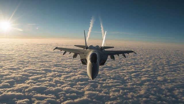 Powerful Fighter Jet Leaving Vapor Trails over Layered Clouds at Sunset